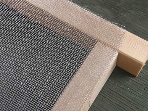 Screen netting is cut to size and put in place